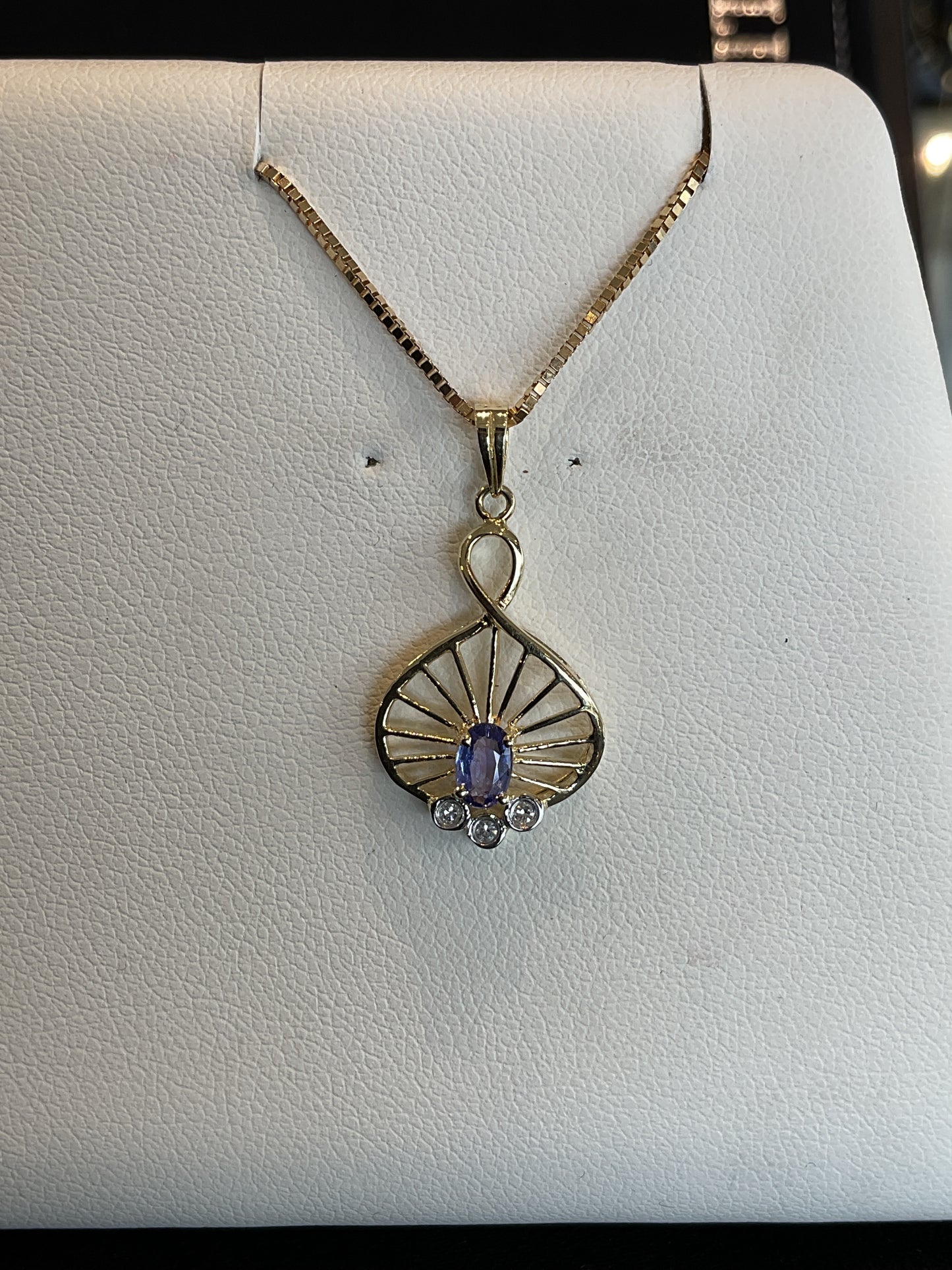 Oval Cut Tanzanite with Tri-Round Brilliant Cut Bezel Set Diamond Accents in Twisted Ray 14KT Yellow Gold Setting Necklace 18" 10KT Yellow Gold Chain